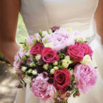 Bride holding colourful flowers